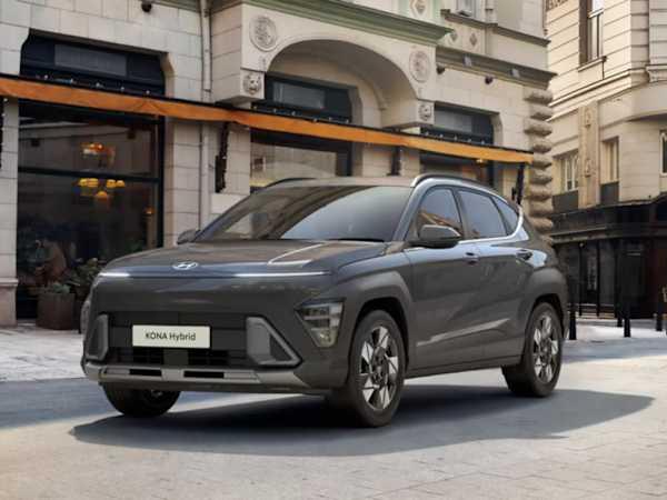 Hyundai KONA Hybrid car in black parked in front of a classic building